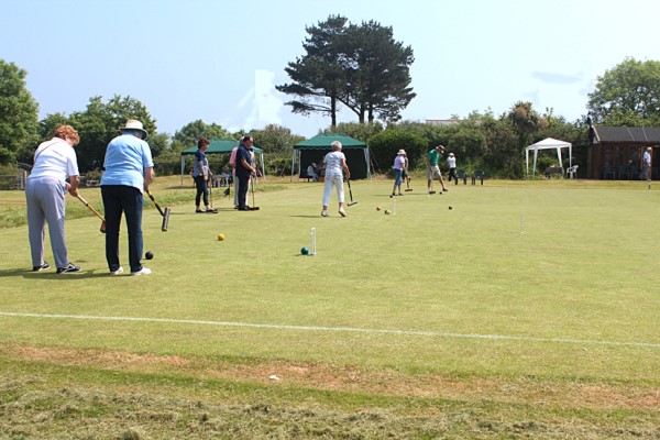 Visitors trying croquet.